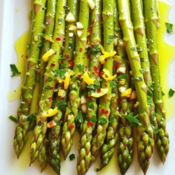 - 1 lb fresh asparagus, trimmed - 3 tablespoons olive oil - 4 cloves garlic, minced Lemon garlic roasted asparagus shines with its fresh taste and bright flavors. The asparagus spears are the star of this dish. Choose firm and vibrant green ones for the best result. The olive oil adds richness and helps the garlic stick. Minced garlic gives a strong flavor that pairs well with lemon. - Zest of 1 lemon - 2 tablespoons fresh lemon juice - 1 teaspoon sea salt - ½ teaspoon black pepper - ¼ teaspoon red pepper flakes (optional for a little heat) Lemon zest and juice bring a bright, tangy flavor that lifts the dish. Sea salt enhances all the flavors, while black pepper adds a hint of spice. If you want some heat, add red pepper flakes. They give a little kick without overpowering the dish. - 2 tablespoons grated Parmesan cheese (optional, for garnish) - Fresh parsley, chopped (for garnish) For a touch of savory richness, sprinkle Parmesan cheese on top. It melts slightly, adding a creamy layer. Fresh parsley brightens the dish with its color and flavor. This dish looks great with just a few sprigs on top. You can find the full recipe [here](#). Preheating your oven to 425°F (220°C) is key. The right temperature helps the asparagus cook evenly. If your oven is too cool, the asparagus may turn soggy. A hot oven gives you that perfect crisp at the tips. Start by mixing the olive oil, minced garlic, lemon zest, lemon juice, sea salt, black pepper, and red pepper flakes in a bowl. Each ingredient adds a punch of flavor. The olive oil helps everything stick to the asparagus. The lemon zest brings a fresh taste. Garlic adds depth. Mix it well to create a balanced marinade. Add the trimmed asparagus to the bowl. Toss the asparagus gently to coat each spear in the marinade. Make sure all the spears get that tasty mix. Spread them out on a baking sheet lined with parchment paper. This helps with cleanup and keeps the asparagus from sticking. Roast them in your preheated oven for 12-15 minutes. Look for tender spears with crispy tips. Enjoy the aroma as they cook! When picking asparagus, look for firm, bright green spears. The tips should be closed and compact. If the tips are open or wilted, choose another bunch. Fresh asparagus is crisp and has a slight sheen. You can snap the ends to check for freshness. If they snap easily, they’re good to go! To know if your asparagus is perfectly roasted, look for a few signs. The spears should be bright green and tender. The tips should be slightly crispy. A good roasting time is around 12 to 15 minutes at 425°F. If they are fork-tender but still have a slight bite, you’ve nailed it. To boost the flavor of your dish, try adding fresh herbs. Basil, thyme, or rosemary work well with asparagus. You can mix these herbs into the marinade for a tasty twist. If you enjoy a bit of heat, consider adding chili flakes or smoked paprika. These spices can elevate your dish and make it even more enjoyable. Always remember, a little goes a long way! {{image_2}} You can change the taste of Lemon Garlic Roasted Asparagus by adding herbs. Fresh herbs like thyme or rosemary bring a new layer of flavor. Simply chop them finely and mix them into your marinade. This small step can elevate your dish. Thyme offers a warm, earthy note, while rosemary adds a fragrant touch. Experiment with these herbs to find what you love. If you want a vegan dish, skip the cheese. The lemon and garlic flavors shine on their own. You can even add nutritional yeast for a cheesy taste without dairy. It gives you a savory kick, perfect for plant-based diets. This keeps the dish light and fresh while catering to different diets. You don’t have to stick to oven roasting. Grilling is a fun way to cook asparagus. It adds a smoky flavor that is hard to beat. Simply toss your seasoned asparagus on the grill for a few minutes. Turn them often until they are tender and slightly charred. Both methods work well, so try them to see which you prefer. For the full recipe, check out the Zesty Lemon Garlic Asparagus Delight 🥦. To keep roasted asparagus fresh, allow it to cool completely. Then, place it in an airtight container. Store it in the fridge for up to three days. Avoid stacking the spears too tightly, as this can cause them to become soggy. If you want to keep them crisp, line the bottom of the container with a paper towel. This helps absorb moisture. When reheating roasted asparagus, aim to use an oven or an air fryer. Preheat your oven to 350°F (175°C). Place the asparagus on a baking sheet, and heat for about 5-10 minutes. This method keeps the asparagus crispy. If using a microwave, heat in short bursts of 30 seconds. Check often to avoid overcooking, as this can make them mushy. Yes, you can freeze Lemon Garlic Roasted Asparagus! However, the texture may change. To freeze, let the asparagus cool and place it in a freezer-safe bag. Remove as much air as possible before sealing. Freeze for up to three months. When you are ready to use it, thaw in the fridge overnight. Then, reheat as mentioned above for the best taste. Roasting asparagus at 425°F takes about 12 to 15 minutes. The time can change based on the size of the asparagus spears. Look for spears that are tender and a bit crispy at the tips. This quick cooking time helps keep the bright green color and crisp texture. Yes, you can prepare this dish ahead of time. You can wash and trim the asparagus and mix the marinade in advance. Store the asparagus and marinade separately in the fridge. When you're ready to eat, toss them together and roast. This saves time on busy nights. Lemon Garlic Roasted Asparagus goes great with many dishes. Try it with grilled chicken for a light meal. It also pairs well with fish, especially salmon. For a vegetarian option, serve it with quinoa or pasta. The bright lemon flavor complements these proteins and grains well. You can find the complete recipe details for Lemon Garlic Roasted Asparagus [here](#). This recipe is simple and packed with flavor, making it a must-try! In this post, we explored how to make Lemon Garlic Roasted Asparagus. I covered the key ingredients and their roles, along with simple steps for perfecting the dish. Don't forget to try fun variations with herbs or different cooking methods. Making this dish is easy and rewarding, plus it pairs well with many meals. Now you have all the tools to enjoy fresh and tasty asparagus at home. Enjoy your cooking!