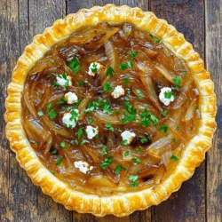 To make a delicious Caramelized Onion and Goat Cheese Tart, you need these simple ingredients: - 1 sheet of puff pastry, thawed - 3 large onions, thinly sliced - 2 tablespoons olive oil - 1 tablespoon balsamic vinegar - 1 teaspoon fresh thyme leaves (or ½ teaspoon dried thyme) - Salt and pepper to taste - 4 oz goat cheese, crumbled - 1 egg, beaten (for egg wash) - Fresh parsley, chopped (for garnish) I prefer fresh herbs for their bright flavor. Fresh thyme brings a lovely taste to the tart. If you only have dried herbs, use half the amount. Dried thyme is strong and can overpower the dish. Always taste as you go to adjust the flavor to your liking. Quality ingredients make a big difference in flavor. Fresh onions caramelize better than older ones. Opt for high-quality olive oil to enhance the taste. The goat cheese should be creamy and tangy. When you use great ingredients, your tart will shine. This will impress your friends and family. They will love every bite! For the full recipe, check out the details above. Before you start, gather all your ingredients. This makes cooking easy and fun. You will need: - 1 sheet of puff pastry, thawed - 3 large onions, thinly sliced - 2 tablespoons olive oil - 1 tablespoon balsamic vinegar - 1 teaspoon fresh thyme leaves (or ½ teaspoon dried thyme) - Salt and pepper to taste - 4 oz goat cheese, crumbled - 1 egg, beaten (for egg wash) - Fresh parsley, chopped (for garnish) Next, preheat your oven to 400°F (200°C). This ensures your tart bakes evenly. Slice the onions thin. This helps them cook well and caramelize nicely. In a large skillet, heat the olive oil over medium heat. Add the sliced onions with a pinch of salt. Stir to coat the onions in the oil. Cook for about 15-20 minutes. Keep stirring often. Watch for the onions to turn soft and golden brown. This is when they begin to caramelize. Add the balsamic vinegar and thyme to the skillet. Stir well and let it cook for another 3-5 minutes. The flavors will blend beautifully. Once done, taste and add more salt and pepper if needed. Remove the skillet from heat and set it aside. Roll out the puff pastry on a lightly floured surface. Flatten any creases. Transfer it to a baking sheet lined with parchment paper. Use a knife to lightly score a border about 1 inch from the edge. Be careful not to cut all the way through. This helps the tart rise while baking. Spread the caramelized onion mixture over the center of the pastry. Leave the scored border clear. Next, sprinkle the crumbled goat cheese over the onions. Brush the edges of the pastry with the beaten egg. This will give your tart a lovely golden finish. Now, bake in your preheated oven for about 25-30 minutes. Look for the pastry to puff and turn golden brown. Once baked, take it out and let it cool for a few minutes. Slice and garnish with chopped fresh parsley. Enjoy your delicious tart! For the complete recipe, check the Full Recipe section. To caramelize onions well, start with low heat. This allows the sugars to break down slowly. Stir the onions often; this keeps them from burning. Adding a little salt helps pull out moisture. For extra depth, try adding balsamic vinegar, as it balances the sweetness. Add herbs like thyme for a fresh taste. It complements the sweetness of the onions. Crumbled goat cheese adds creaminess. When it melts, it creates a rich, savory layer. You can also mix in some grated Parmesan for a stronger flavor. A sprinkle of fresh parsley adds a nice touch at the end. Don’t rush the cooking process. High heat can burn the onions, ruining their flavor. Avoid using too much oil; just enough to coat the onions works best. Another mistake is overcrowding the pan. Make sure there is space for the onions to cook evenly. If you follow these tips, your tart will taste amazing. For a detailed recipe, check the Full Recipe. {{image_2}} You can swap goat cheese for other cheeses. Try feta for a saltier touch. Cream cheese adds a rich, smooth texture. For a sharper flavor, use blue cheese. Each choice changes the taste and feel of the tart. Add veggies for more color and flavor. Spinach pairs well with the onions. Asparagus brings a fresh crunch. Roasted red peppers add sweetness. Choose what's fresh in your market for the best taste. The result is a vibrant tart that shines with seasonal flavors. Making this tart gluten-free is easy. Use gluten-free puff pastry or a homemade crust from almonds. For a vegan version, replace goat cheese with cashew cheese or nutritional yeast. Use olive oil instead of the egg wash. These swaps keep the tart delicious and friendly for all diets. To keep your leftover tart fresh, place it in an airtight container. You can also cover it tightly with plastic wrap. Store it in the fridge for up to three days. This helps keep the flavors intact while preventing it from drying out. When you want to enjoy the tart again, preheat your oven to 350°F (175°C). Place it on a baking sheet. Heat for about 10-15 minutes. This method warms the tart evenly and keeps the pastry crispy. Avoid the microwave; it makes the pastry soggy. Freezing is a great option for longer storage. First, let the tart cool completely. Then, wrap it tightly in plastic wrap. After that, place it in a freezer-safe bag or container. You can freeze it for up to three months. When ready to eat, thaw it overnight in the fridge. Reheat in the oven as mentioned above for the best taste. For a full recipe, check out the Caramelized Onion and Goat Cheese Tart. To get a flaky puff pastry, keep it cold. Work quickly and avoid warming it. Roll it out gently to maintain its layers. Always use a hot oven to help the layers puff up. The steam from baking creates the flaky texture you want. Yes, you can use pre-made caramelized onions. This saves time and effort. Just make sure they taste good. Check for added sugars or flavors that might not fit your dish. You want the sweet, deep flavor that complements goat cheese well. Several sides go well with this tart. Here are some great options: - Simple green salad: A fresh salad with lemon vinaigrette balances the tart. - Roasted vegetables: Sweet carrots or earthy beets add color and flavor. - Soup: A light tomato or butternut squash soup is comforting and pairs nicely. These sides make your meal complete and enjoyable. Check the Full Recipe for more ideas! In this post, we covered how to make a Caramelized Onion and Goat Cheese Tart. We discussed ingredient choices, preparation steps, and expert tips for great results. We also explored variations and storage methods to keep your tart fresh. Quality ingredients and proper techniques are key for your tart's success. Follow these guidelines to impress anyone at your next meal. Enjoy experimenting with flavors and make this dish your own!