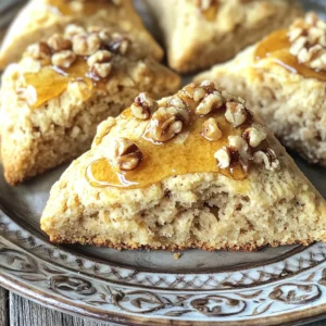 To make these bakery-style maple brown sugar scones, gather these key ingredients: - 2 cups all-purpose flour - 1/2 cup packed brown sugar - 1 tablespoon baking powder - 1/2 teaspoon salt - 1/2 cup unsalted butter, cold and cubed - 1/2 cup heavy cream - 1/4 cup pure maple syrup - 1 large egg - 1 teaspoon vanilla extract These ingredients blend to create a light and fluffy scone. The brown sugar adds a warm sweetness, while the maple syrup gives a lovely flavor. You can enhance your scones with these optional add-ins: - 1/2 cup chopped walnuts or pecans - Extra maple syrup for drizzle Adding nuts gives a nice crunch and flavor. The drizzle of syrup makes your scones even more appealing. To make your baking easier, gather these tools: - Large mixing bowl - Whisk - Pastry cutter or fingertips for mixing - Parchment paper for lining the baking sheet - Baking sheet These tools help you mix, shape, and bake your scones perfectly. First, you need to preheat your oven to 400°F (200°C). Line a baking sheet with parchment paper. In a large bowl, mix 2 cups of all-purpose flour, 1/2 cup of packed brown sugar, 1 tablespoon of baking powder, and 1/2 teaspoon of salt. Whisk these until they are well combined. Next, add 1/2 cup of cold, cubed unsalted butter. You can use a pastry cutter or your fingers to work the butter into the flour. Keep mixing until it looks like coarse crumbs. In a separate bowl, whisk together 1/2 cup of heavy cream, 1/4 cup of pure maple syrup, 1 large egg, and 1 teaspoon of vanilla extract. Make sure this mix is smooth. Pour these wet ingredients into the dry mix. Gently stir until they just combine. If you want nuts, fold in 1/2 cup of chopped walnuts or pecans here. The dough will feel a bit sticky. Now, turn the dough onto a lightly floured surface. Gently knead it a few times to bring it together. Shape the dough into a circle about 1-inch thick. Use a sharp knife or a pizza cutter to slice the dough into 8 wedges. Place the wedges on the prepared baking sheet, leaving some space between them. Bake the scones for 15 to 18 minutes. They should turn golden brown on top when done. Once baked, take them out of the oven and let them cool slightly on the sheet. If you like, you can drizzle some extra maple syrup on top for added sweetness. Enjoy your fresh scones warm! To get that perfect bakery-style texture in your scones, start with cold butter. Cold butter helps create flaky layers. Cut the butter into small cubes and mix it with the flour quickly. You want the mixture to look like coarse crumbs. This step is key! Next, avoid over-mixing your dough. Mix just until the ingredients come together. If the dough feels sticky, that's okay. Lightly flour your surface when kneading. This keeps the texture light and airy. For deeper flavor, use high-quality maple syrup. It adds richness and sweetness. If you want a nutty crunch, add walnuts or pecans. This gives your scones a lovely texture. You can also try adding spices like cinnamon or nutmeg. A pinch of these spices brings warmth to the flavor. For a twist, consider adding dried fruits like cranberries or apricots. They pair well with the maple flavor. One common mistake is using room temperature butter. This can lead to dense scones. Always use cold butter. Another mistake is not measuring the flour correctly. Scooping flour directly from the bag can pack it down. Instead, spoon it into your measuring cup and level it off. Lastly, do not skip the resting time after mixing. Letting the dough sit for a few minutes helps the flavors meld. This small step makes a big difference in taste! {{image_2}} You can easily make these scones nut-free. Simply skip the chopped walnuts or pecans. The scones will still taste great. They will be soft and sweet, just like the original. You can add more flavor with spices or choose a different mix-in. Feel free to swap flavors to suit your taste. You can add chocolate chips for a sweet twist. Dark chocolate adds richness. You can also use dried fruits like cranberries or apricots. They bring a chewy texture and tartness. Try adding lemon zest for a bright kick. Each of these swaps adds a fun touch to your scones. If you want to change up the glaze, there are tasty options. Instead of maple syrup, use a simple icing. Mix powdered sugar with milk until smooth. You can add a splash of vanilla or almond extract for more flavor. Another option is a honey drizzle. It gives a nice sweetness and pairs well with the scones. To keep your leftover scones fresh, store them in an airtight container. Place a piece of parchment paper between layers to prevent sticking. Keep them at room temperature for up to two days. If you want them to last longer, refrigerate them for up to a week. When you are ready to enjoy a scone, preheat your oven to 350°F (175°C). Place the scone on a baking sheet and heat for about 5-7 minutes. This warms them up and brings back that fresh-baked taste. You can also microwave them for 10-15 seconds if you are in a hurry, but the oven gives a better texture. If you want to save scones for later, freezing works great. Wrap each scone tightly in plastic wrap. Then, place them in a freezer bag or container. They will stay good for up to three months. When you are ready to eat them, let them thaw overnight in the fridge. Reheat them in the oven for best results. You can tell when scones are done by their color. They should be golden brown on top. You can also gently tap the top. If it sounds hollow, they are ready. Keep an eye on them while baking. Every oven is a bit different. Start checking at 15 minutes. If they need more time, check every minute after that. Yes, you can make the dough ahead of time! Prepare the dough and shape it into a circle. Wrap it in plastic wrap and chill it in the fridge. This lets the flavors blend well. You can store it for up to 24 hours. When ready, cut into wedges and bake as usual. This saves time on busy mornings. These scones taste great with many things! You can serve them with butter or jam. A drizzle of extra maple syrup adds sweetness. They also pair well with coffee or tea. If you want something more filling, add cheese or fruit. Fresh fruit like berries complements the scones nicely. Enjoy them with your favorite drink or spread! Making scones is simple and fun. We covered the key ingredients and tools you need. I shared step-by-step instructions for perfect dough, shaping, and baking. You learned tips for getting a great texture and avoiding common mistakes. We also explored tasty variations and how to store extras. With these ideas, you can bake scones like a pro. Enjoy experimenting with flavors and sharing your creations!