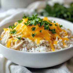 To make Crock Pot Ranch Chicken, you need a list of simple items. Gather these ingredients for a creamy delight that everyone will love. - 4 boneless, skinless chicken breasts - 1 packet (1 oz) ranch dressing mix - 1 can (10.5 oz) cream of chicken soup - 1 cup low-sodium chicken broth - 1 cup sour cream - 1 tablespoon garlic powder - 1 teaspoon onion powder - 1/2 teaspoon black pepper - 1 cup shredded cheddar cheese - Fresh parsley, chopped (for garnish) Each ingredient plays a key role. The chicken is tender and juicy. The ranch dressing mix adds great flavor. Cream of chicken soup creates a rich base. Sour cream gives it a nice creaminess. Garlic and onion powder add depth. Black pepper brings a little heat, while cheddar cheese melts perfectly on top. Don't forget the parsley for a fresh finish! This recipe serves 4 to 6 people, making it great for families or gatherings. Enjoy this comfort meal with a side of rice or mashed potatoes. {{ingredient_image_1}} To start, we need to create the creamy base for our dish. In the bottom of your crock pot, combine: - 1 packet (1 oz) ranch dressing mix - 1 can (10.5 oz) cream of chicken soup - 1 cup low-sodium chicken broth - 1 tablespoon garlic powder - 1 teaspoon onion powder - 1/2 teaspoon black pepper Mix these ingredients well. This simple blend will bring rich flavor to the chicken. Next, add the chicken breasts into this mixture. Make sure each piece is well coated. This helps the chicken absorb all the tasty flavors. Now, choose your cooking time. You can set the crock pot to cook on low for 6-7 hours. If you're in a hurry, you can cook it on high for 3-4 hours. Either way, the chicken will turn out tender. When the cooking time is almost up, it’s time to shred the chicken. About 30 minutes before serving, remove the chicken from the pot. Use two forks to shred it into bite-sized pieces. Then, return the shredded chicken to the crock pot. Now, stir in: - 1 cup sour cream - 1/2 cup shredded cheddar cheese Mix everything until well combined. This will add creaminess and flavor to your dish. Cover and let it cook on low for another 30 minutes. This will heat everything through nicely. Before serving, sprinkle the remaining cheddar cheese on top of the chicken. Let it melt slightly for that gooey goodness. For a touch of color, garnish with freshly chopped parsley. The green adds a lovely pop to your meal. Serve this dish over a bed of fluffy rice or mashed potatoes. Drizzle the creamy sauce on top for a delightful finish. Enjoy your comforting bowl of Crock Pot Ranch Chicken! To ensure your chicken stays tender, use boneless, skinless chicken breasts. Cooking them low and slow in the crock pot helps lock in moisture. If you have time, let the chicken marinate overnight in the ranch dressing mix. This adds flavor and makes it super juicy. For shredding chicken easily, let it rest for a few minutes after cooking. Use two forks to pull the meat apart. The chicken will shred better when it’s warm. If you want faster shredding, try using a hand mixer on low speed. Just be careful not to overdo it! For serving, a bed of fluffy rice or creamy mashed potatoes works well. Spoon the ranch chicken and sauce over the top. This adds a nice touch and makes the meal feel complete. Garnish your dish with fresh parsley. Sprinkle a bit of black pepper on top for extra flavor and color. This little detail makes your meal look fancy and inviting. Enjoy your creamy comfort meal! Pro Tips Use Fresh Herbs: Incorporating fresh herbs like thyme or rosemary can elevate the flavor profile of your ranch chicken, giving it a fresh and aromatic twist. Adjust Seasoning: Feel free to adjust the seasoning according to your taste. Adding a pinch of cayenne pepper or paprika can give the dish a nice kick. Perfect Shredding: For perfectly shredded chicken, let it rest for a few minutes after cooking before shredding. This allows the juices to redistribute, keeping the chicken moist. Leftover Ideas: Use any leftover ranch chicken in salads, wraps, or sandwiches for a quick and delicious meal the next day. {{image_2}} You can change up the flavors in this dish with a few simple swaps. For alternative spices, try adding Italian seasoning or taco seasoning instead of ranch mix. These spices bring a new twist to the flavor. You may also use paprika or cumin for a warm taste. Just remember to adjust the amount to your liking. If you want a dairy-free option, swap out the sour cream. Use coconut cream or cashew cream. Both will give a nice creamy texture without dairy. You can also use dairy-free cheese if you want to keep that cheesy flavor. These swaps make the meal fit various diets while still being tasty. Pairing is key to a great meal. Serve your ranch chicken over fluffy rice or creamy mashed potatoes. Both options soak up the sauce well. You can also try it with egg noodles for a comforting twist. If you want to get creative, turn this dish into a casserole. After mixing in the sour cream and cheese, pour it into a baking dish. Top it with breadcrumbs or more cheese. Bake it in the oven at 350°F for about 20 minutes. This adds a crunchy top that everyone will love. After enjoying your Crock Pot Ranch Chicken, store any leftovers safely. First, let the dish cool down to room temperature. Then, place the chicken in an airtight container. Make sure to cover it well to keep it fresh. Store the container in the fridge. This dish lasts up to four days when stored properly. If you want to keep it longer, consider freezing it. Use a freezer-safe container or a heavy-duty freezer bag. Remove as much air as you can before sealing. Label the bag with the date. Frozen ranch chicken will stay good for up to three months. When you're ready to enjoy your leftovers, there are good methods for reheating. The best way is to use the stove. Place the chicken in a pan over low heat. Add a splash of chicken broth or water to keep it moist. Stir often until it’s heated through. You can also use the microwave. Place a portion on a microwave-safe plate. Cover it with a microwave-safe lid or wrap. Heat on medium power for one minute, then check and stir. Heat in short bursts until warm. Enjoy your meal again with ease! Yes, you can use frozen chicken breasts! Just keep in mind that it will take longer to cook. When using frozen chicken, set your crock pot to high and cook for about 4-5 hours. Always check that the chicken reaches 165°F for safety. Crock Pot Ranch Chicken lasts about 3-4 days in the fridge. Make sure to store it in an airtight container to keep it fresh. Before eating, always check for any signs of spoilage. Yes, you can make this in an Instant Pot! Use the sauté function to mix your base. Then, add the chicken and broth. Cook on high pressure for about 10-12 minutes. Let it naturally release for about 10 minutes before shredding the chicken. It’s easy and quick! This blog post covered a simple and tasty recipe for Crock Pot Ranch Chicken. We reviewed the key ingredients, preparation steps, and cooking tips. You learned how to enhance the dish with variations and maximize storage. In the end, this meal is easy to make and delicious. It’s perfect for busy days, family dinners, or meal prep. Enjoy the creamy goodness and flavorful twists to make it your own!