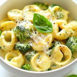 To create a delicious Creamy Chicken Tortellini with Broccoli, gather the following ingredients: - 2 cups cheese tortellini, fresh or frozen - 1 cup cooked chicken, shredded or diced - 2 cups broccoli florets - 1 cup heavy cream - 1 cup chicken broth - 1 tablespoon olive oil - 1 teaspoon garlic powder - 1 teaspoon onion powder - Salt and pepper to taste - 1/2 cup grated Parmesan cheese - Fresh basil leaves for garnish These ingredients blend together to create a rich and creamy dish. The cheese tortellini adds a soft texture, while the broccoli provides a fresh crunch. Using cooked chicken speeds up prep time and keeps it simple. Heavy cream and chicken broth form the base of the creamy sauce, giving it a rich flavor. Garlic and onion powder enhance the taste without overpowering the dish. Salt and pepper are crucial for balancing the flavors. Finally, the grated Parmesan cheese melts in beautifully, adding depth to the sauce. Garnishing with fresh basil leaves adds color and a hint of freshness. With these ingredients, you're ready to make a comforting meal that everyone will love. {{ingredient_image_1}} Start by boiling salted water in a large pot. When the water is ready, add the fresh broccoli florets. Cook them for about three minutes. They should turn bright green and feel tender-crisp. Use a slotted spoon to take the broccoli out. Set it aside on a plate for later. In the same pot, add the cheese tortellini. Follow the package instructions closely, which usually suggest cooking for three to five minutes. Once they are done, drain the tortellini. Place them next to the broccoli on the plate. Heat one tablespoon of olive oil in a large skillet over medium heat. Once the oil is warm, add one cup of heavy cream and one cup of chicken broth. Stir the mixture well and bring it to a gentle simmer. To enhance the flavor, add one teaspoon each of garlic powder and onion powder. Sprinkle in some salt and pepper to taste. Stir the sauce well and let it cook for two to three minutes. This helps the flavors meld together nicely. Now, it’s time to bring everything together. Add the cooked chicken, tortellini, and broccoli into the skillet. Gently toss all the ingredients together. Make sure every piece is coated with the creamy sauce. To finish, take the skillet off the heat. Stir in half a cup of grated Parmesan cheese. This will make the sauce creamy and smooth. Taste the dish and adjust the seasoning if needed. Now you’re ready to serve! To get the right creamy sauce, focus on the thickness. Start with equal parts heavy cream and chicken broth. This mix gives a wonderful base. Stir slowly and let it simmer to thicken. If the sauce seems too thick, add a splash of broth. If it’s too thin, cook it a bit longer. To keep your sauce smooth, avoid high heat. High heat can cause the cream to curdle. Instead, use medium heat and stir often. If you notice curdling, reduce the heat immediately. You can also whisk in a little more broth to save it. If you want a change from chicken, try turkey or cooked shrimp. Both add a nice twist. For a vegetarian option, use chickpeas or tofu. These alternatives are tasty and healthy. You might want to switch up the pasta too. While tortellini is great, other pastas work well too. Try penne or farfalle for a different texture. Just make sure to cook them according to the package. This dish pairs nicely with a simple side salad. A fresh green salad with lemon vinaigrette complements the creaminess. You can also serve it with crusty bread. The bread helps soak up the sauce. For presentation, use a large bowl and spoon the dish in carefully. Garnish with fresh basil leaves for a pop of color. You could add extra Parmesan on top for a rich look. Pro Tips Fresh vs. Frozen Tortellini: Using fresh tortellini will give you a more delicate texture and flavor, but frozen is convenient and works well if you're short on time. Broccoli Cooking Time: Be careful not to overcook the broccoli; blanching it for just 3 minutes ensures it stays vibrant and crunchy in your dish. Customize the Sauce: You can add a splash of white wine or a pinch of red pepper flakes to the sauce for an extra layer of flavor that complements the creaminess. Perfect Parmesan: For the best melting quality, use freshly grated Parmesan cheese, as pre-grated versions often contain anti-caking agents that can affect the texture. {{image_2}} You can make your creamy chicken tortellini even better by adding more veggies. Try adding spinach, bell peppers, or peas. These add color and nutrients. When adding veggies, adjust the cooking time. For example, add spinach at the same time as the chicken. For bell peppers or peas, add them during the last minute of cooking. This keeps them crisp and bright. To make this dish vegetarian, swap the chicken for a plant-based protein. You can use tofu, chickpeas, or lentils. Tofu works well when cubed and sautéed. Chickpeas can add a nice texture. Lentils will give a hearty feel to the meal. You can keep the rest of the recipe the same. This way, you still enjoy the creamy sauce and tortellini. If you like heat, make a spicy version of this dish! Add red pepper flakes or diced jalapeños to the sauce. Start with a little and taste as you go. You can also use spicy chicken broth instead of regular broth. This adds flavor and heat. Adjust the cooking method by simmering the sauce a bit longer. This helps the spices blend well. Enjoy your spicy twist on this classic dish! To keep your creamy chicken tortellini fresh, store leftovers in the fridge. Place it in airtight containers. This helps keep the flavors intact. Use glass or plastic containers, as they are great for storage. When you reheat, use a skillet. This method helps keep the creaminess. Heat it on low and stir often. You can also add a splash of chicken broth to prevent it from drying out. This keeps your dish smooth and tasty. If you want to freeze it, let the dish cool completely first. Use freezer-safe containers or bags. When you’re ready to eat, thaw it in the fridge overnight. Reheat in a skillet, adding a little broth to restore creaminess. Enjoy your meal later! Yes, you can use frozen tortellini. Just cook it according to the package instructions. Usually, it takes about 3-5 minutes in boiling water. Make sure to add the frozen tortellini to boiling, salted water to keep it firm. Stir gently to prevent sticking. After cooking, drain and set it aside with the broccoli. This dish lasts about 3-4 days in the fridge. Store it in an airtight container to keep it fresh. Check for signs of spoilage, like an off smell or mold. If it smells sour or looks strange, it's best to throw it away. Yes, you can prepare this dish in advance. Cook the tortellini and broccoli, then store them separately. Make the creamy sauce and keep it in the fridge. When you are ready to eat, combine everything in a skillet and heat until warm. This saves time on busy nights. Absolutely! Kids love cheesy pasta dishes. To make it even more appealing, cut the broccoli into smaller pieces. You can also let them help mix the ingredients. The creamy sauce and cheese make it tasty and fun. Add extra cheese on top for a special touch! This dish combines easy steps and delicious ingredients to make a creamy chicken tortellini. You can cook the broccoli and tortellini quickly, then create a rich sauce with simple spices. Don’t hesitate to try variations, like adding more veggies or making it spicy. Remember, leftovers store well, and you can reheat them so they taste great. Enjoy this tasty meal with your family, and make it your own!