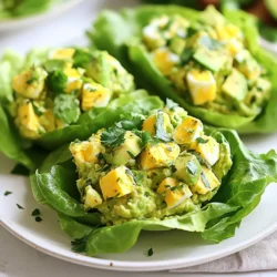 To make avocado egg salad lettuce wraps, gather the following ingredients: - 4 hard-boiled eggs, peeled and chopped - 1 ripe avocado, mashed - 2 tablespoons Greek yogurt (or mayonnaise) - 1 tablespoon Dijon mustard - 1 tablespoon lemon juice - 1 green onion, finely chopped - Salt and pepper to taste - 8 large lettuce leaves (Romaine or Butter lettuce works well) - Optional: Fresh herbs (cilantro or parsley), for garnish If you need some swaps, here are some ideas: - Use mashed ripe banana instead of avocado for a sweet twist. - Swap Greek yogurt for silken tofu for a vegan option. - Use yellow mustard if you lack Dijon mustard. - Replace green onions with chives or red onion for a different flavor. Let’s break down the health perks of these ingredients: - Hard-boiled eggs: They provide protein and essential vitamins like B12 and D. - Avocado: Packed with healthy fats and fiber, avocados help with heart health. - Greek yogurt: A great source of protein and probiotics, it aids digestion. - Dijon mustard: This adds flavor with low calories and some antioxidants. - Lemon juice: It offers vitamin C, which boosts immunity and skin health. - Green onion: Rich in vitamins A, C, and K, they support overall health. - Lettuce: Low in calories, it’s high in water and helps with hydration. - Fresh herbs: They add flavor and are rich in antioxidants and nutrients. These ingredients come together to create a dish that is not only tasty but also packed with nutrition. {{ingredient_image_1}} Start by gathering all your ingredients. You need: - 4 hard-boiled eggs, peeled and chopped - 1 ripe avocado, mashed - 2 tablespoons Greek yogurt (or mayonnaise) - 1 tablespoon Dijon mustard - 1 tablespoon lemon juice - 1 green onion, finely chopped - Salt and pepper to taste - 8 large lettuce leaves (Romaine or Butter lettuce works well) - Optional: Fresh herbs (cilantro or parsley), for garnish Make sure your eggs are hard-boiled. You can boil them ahead of time. The avocado should be ripe and easy to mash. This makes the salad creamy and rich. The lettuce leaves should be big enough to hold the filling. Romaine or Butter lettuce is great for this dish. In a mixing bowl, combine the chopped hard-boiled eggs and mashed avocado. Use a fork to mash them together. This helps blend the flavors. Next, add the Greek yogurt or mayonnaise, Dijon mustard, and lemon juice. Mix everything well until it looks creamy. The mayo or yogurt adds richness, while the mustard gives it a nice kick. Then, fold in the finely chopped green onion. This adds a fresh taste. Season with salt and pepper to your liking. Taste it as you go! Now it’s time to assemble your wraps. Take a large lettuce leaf and spoon about 2-3 tablespoons of the egg salad onto the center. Make sure not to overfill it. You want to wrap it easily. If you like, sprinkle some fresh herbs on top for added flavor and color. Then, gently wrap the lettuce around the filling. This creates a fun, handheld meal. Repeat this with the rest of the lettuce leaves and egg salad. Enjoy your fresh and flavorful avocado egg salad lettuce wraps! To get the best texture, mash the avocado well. It should be smooth, not chunky. Mix the avocado with the chopped eggs gently. This keeps the eggs intact while blending flavors. Use Greek yogurt for creaminess but not too much. Start with two tablespoons and adjust as needed. The goal is a creamy but not runny mix. If you like, add fresh herbs for a little crunch. Store any leftover egg salad in an airtight container. It stays fresh in the fridge for up to three days. Make sure to seal it well to keep it from drying out. If you notice the salad getting watery, stir gently before serving. You can also add more seasoning to freshen it up. These wraps are great for lunch or snacks. Serve them on a plate or in a lunch box. You can add slices of cucumber or tomato on the side for color. If you want extra crunch, try adding sliced radishes. For a fun twist, serve with a dipping sauce like ranch or a spicy mayo. Pro Tips Use Ripe Avocados: For the best flavor and creaminess, ensure your avocado is ripe. It should yield slightly to pressure when squeezed gently. Customize Seasoning: Feel free to experiment with spices like paprika or garlic powder to enhance the flavor profile of your egg salad. Chill Before Serving: For a refreshing taste, refrigerate the egg salad for about 30 minutes before serving. This allows the flavors to meld together. Choose the Right Lettuce: Romaine or Butter lettuce works best for wraps due to their sturdy leaves, which can hold the filling without tearing. {{image_2}} You can use many kinds of lettuce for your wraps. Romaine is crisp and sturdy. It holds the filling well. Butter lettuce is soft and has a lovely flavor. It wraps easily, making it a favorite. You can also try iceberg if you want a crunch. Each type adds a unique taste and texture. Adding more ingredients can enhance your avocado egg salad. Consider diced bell peppers for a sweet crunch. Chopped celery adds a nice bite. You might like to sprinkle in some paprika for extra flavor. Fresh herbs like cilantro or dill brighten up the dish. Don’t forget to adjust salt and pepper as you add these extras. While Greek yogurt or mayonnaise is great, you can try other dressings. A splash of hot sauce adds a kick. You might also enjoy a dollop of pesto for a herby touch. If you want a tangy twist, use a bit of vinegar. Each option brings its own flavor to the salad, making it fun to experiment. Store your avocado egg salad in an airtight container. This keeps it fresh and tasty. It is best to refrigerate it right after making. If you plan to eat it later, cover it tightly. This helps to avoid drying out or picking up other smells from the fridge. Freezing avocado egg salad is not ideal. The texture changes when frozen, making it watery. If you must freeze it, use a freezer-safe container. Keep in mind that the avocado may turn brown, and the salad may not taste as fresh when thawed. In the fridge, your avocado egg salad lasts about 3 to 4 days. Always check for signs of spoilage, like off smells or color changes. To keep it fresh, you can prepare the salad without avocado and mix it in before serving. This way, you enjoy the best taste and texture. Yes, you can make this dish vegan! To do this, replace the eggs with chickpeas. Mash the chickpeas to get a similar texture. Use avocado, vegan yogurt, and mustard just like the recipe states. You can also add spices for more flavor. This vegan twist keeps the dish creamy and tasty. The egg salad lasts about three to five days in the fridge. Store it in an airtight container to keep it fresh. If you notice any change in smell or color, it’s best to throw it away. Enjoy your salad within this time for the best taste. There are many fun ways to serve this salad! You can use different types of lettuce, like Romaine or Butter lettuce. Try adding it to whole grain bread for a sandwich. You can also serve it in bell pepper halves or on cucumber slices. For a crunchy bite, top it with nuts or seeds. The options are endless! This blog post covered how to make delicious avocado egg salad lettuce wraps. We explored key ingredients and their health benefits. We walked through preparation and mixing steps for perfect wraps. Tips helped you achieve the right texture and store leftovers. We also shared fun variations to keep it fresh. Finally, we answered common questions for your convenience. Enjoy making these wraps for a tasty and healthy meal!