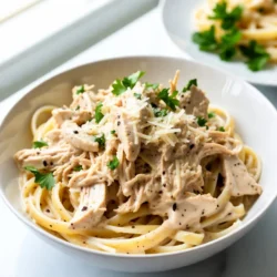 For a tasty Slow Cooker Chicken Alfredo, gather these main ingredients: - 2 boneless, skinless chicken breasts - 2 cups chicken broth - 1 cup heavy cream - 1 cup grated Parmesan cheese - 3 cloves garlic, minced - 1 teaspoon Italian seasoning - 1 teaspoon black pepper - 1/2 teaspoon salt - 8 ounces fettuccine pasta - Fresh parsley, chopped (for garnish) You can customize your dish with these optional ingredients: - 1 cup broccoli florets - 1 cup spinach Adding these greens gives extra flavor and nutrition. You can mix and match based on what you like. Using high-quality ingredients makes a big difference. Fresh chicken tastes better and cooks well. Look for low-sodium chicken broth to control salt levels. Use real Parmesan cheese for a rich flavor. Avoid pre-grated cheese, as it often has fillers. Fresh garlic adds a stronger taste compared to jarred garlic. Always check the dates on dairy products like heavy cream. Fresh ingredients lead to a creamy and delicious meal. {{ingredient_image_1}} Start by placing two boneless, skinless chicken breasts in your slow cooker. Season the chicken with salt, black pepper, and Italian seasoning. This helps create great flavor. Next, add three minced garlic cloves on top of the chicken. Pour two cups of chicken broth over everything. This broth keeps the chicken moist and tasty. Cover the slow cooker with its lid. Set the cooker on low heat. Let the chicken cook for 4 to 5 hours. You want the chicken to be tender and fully cooked. After cooking, take the chicken out. Use two forks to shred it into pieces. Return the shredded chicken back into the slow cooker. Now, stir in one cup of heavy cream and one cup of grated Parmesan cheese. Mix until everything is combined. If you like greens, toss in one cup of broccoli florets or spinach now. Add eight ounces of uncooked fettuccine pasta to the slow cooker. Gently press the pasta into the sauce. Cover the cooker again. Cook on low for an additional 30 to 40 minutes. Check to see that the pasta is tender. Once done, stir the pasta and sauce well. Make sure everything is coated. Taste it and adjust the seasoning if you need more salt or pepper. Serve hot and garnish with fresh chopped parsley for a nice touch. To boost the taste, focus on your seasonings. I love using Italian seasoning. It adds a nice herb flavor. You can also try garlic powder for more depth. If you want some heat, add a pinch of red pepper flakes. Season the chicken well before cooking. This helps lock in the flavors as it cooks. When your chicken is done, let it cool for a few minutes. This makes it easier to handle. Use two forks to shred the chicken. Hold one fork in each hand. Pull apart the chicken with the forks. Aim for bite-sized pieces. This helps it mix well with the sauce. To make your dish even creamier, add more heavy cream. A little extra cheese can help too. I like to stir in some cream cheese for richness. If you want to lighten it up, use half-and-half instead. Just make sure to mix well until smooth. This gives you that dreamy Alfredo sauce we all love! Pro Tips Use Fresh Ingredients: Fresh garlic and high-quality Parmesan cheese can elevate the flavor of your Alfredo sauce significantly. Customize Your Veggies: Adding vegetables like broccoli or spinach not only enhances nutrition but also adds color and texture to your dish. Perfect Pasta Cooking: Keep an eye on the pasta while it cooks in the slow cooker to ensure it reaches your desired level of tenderness without becoming mushy. Leftover Storage: Store any leftovers in an airtight container in the fridge for up to 3 days. Reheat gently on the stove with a splash of cream to restore creaminess. {{image_2}} You can easily add veggies to boost nutrition. Broccoli and spinach work great. Toss in one cup of broccoli florets or fresh spinach when you mix in the cream and cheese. This adds color and crunch. You can also try peas or bell peppers. They add taste and extra vitamins. Fettuccine is classic for Alfredo, but you can switch it up. Try penne or rotini if you prefer. Whole wheat or gluten-free pasta is also a good choice. Just keep an eye on cooking time. Different pasta may cook faster or slower, so adjust as needed. If you want to change the protein, chicken is not the only option. You can use turkey breast for a lighter meal. Shrimp also fits well in this dish. Just add the shrimp during the last 30 minutes of cooking. For a vegetarian option, try chickpeas or tofu. Both add protein and take on the creamy sauce's flavor. To keep your Slow Cooker Chicken Alfredo fresh, store it in an airtight container. Let the dish cool down before sealing it. This helps prevent condensation. You can store it in the fridge for up to three days. Make sure to label the container with the date. This way, you can track how long it's been stored. When you're ready to enjoy leftovers, reheat carefully. You can use a microwave or a stovetop. If using a microwave, place the food in a bowl and cover it. Heat in short bursts, stirring in between to ensure even warming. If using the stovetop, add a splash of chicken broth to the pan. Stir over low heat until it’s warm. This helps keep the sauce creamy. You can freeze Slow Cooker Chicken Alfredo for up to three months. First, let it cool completely. Then, portion it into freezer-safe containers. Be sure to leave some space for expansion. To thaw, place the container in the fridge overnight. Reheat as mentioned above. You may need to add a little cream or broth to restore the sauce's creaminess. Yes, you can use frozen chicken! Just add an extra hour to the cooking time. This will help the chicken cook through. Make sure to check that it's fully cooked before shredding. To make this dish gluten-free, swap regular fettuccine for gluten-free pasta. Many brands offer great options that cook well. You should also check the chicken broth for gluten-free labeling. You can serve this dish with a fresh green salad for crunch. Garlic bread is also a great side. If you want more veggies, steamed broccoli pairs nicely. For a light touch, try a simple fruit salad. This article covered key points for making delicious Slow Cooker Chicken Alfredo. We explored important ingredients, step-by-step cooking methods, and helpful tips to enhance flavor. You also learned about variations to suit your tastes and storage options for leftovers. In summary, this dish is easy and fun to make. It adapts well to different diets and preferences. Enjoy your cooking and savor every bite!